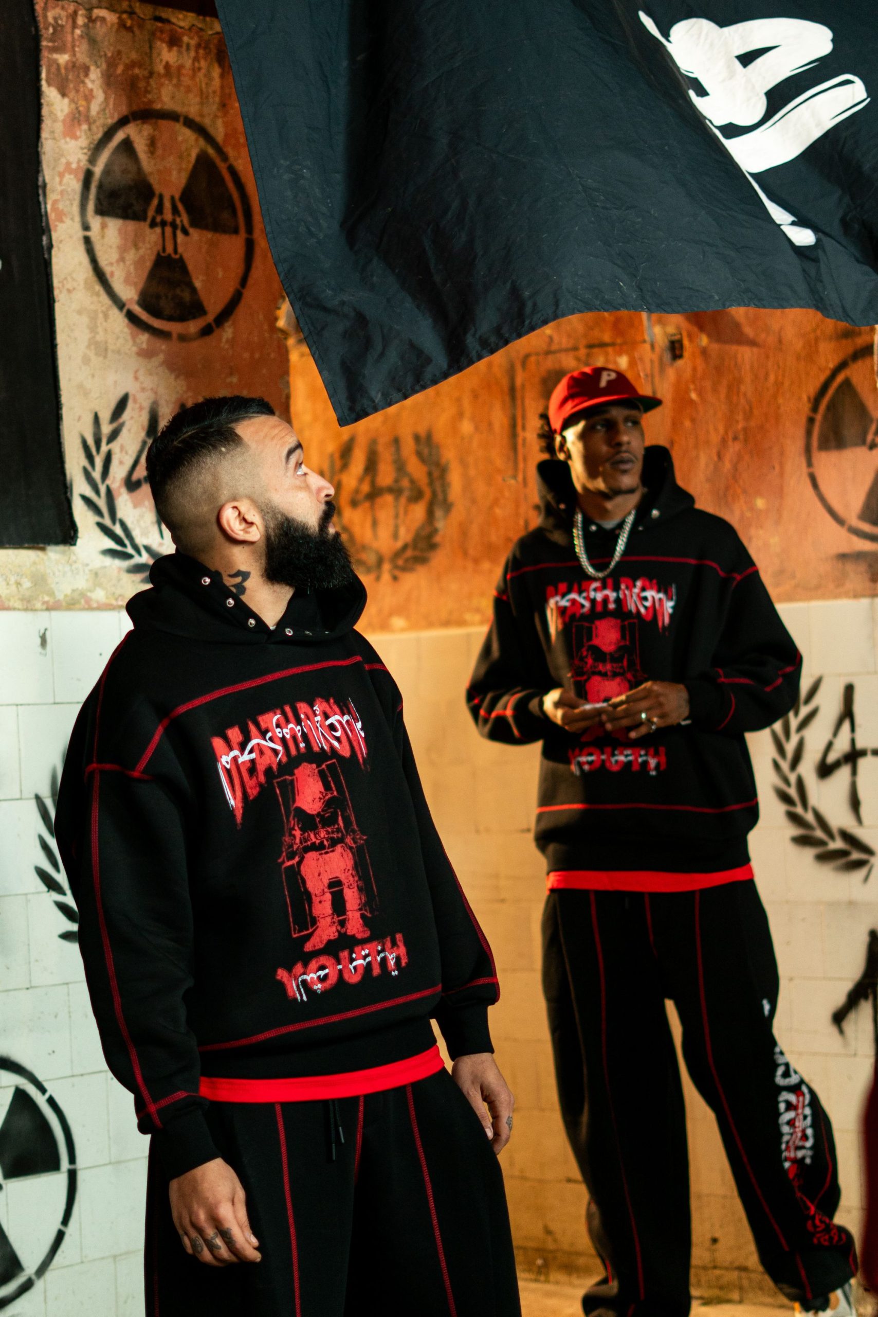 Orbital Utility Jacket Streetwear shoot against a graffiti wall