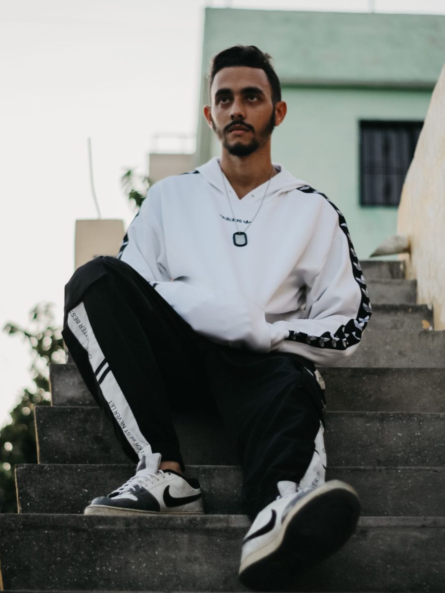 Customer in streetwear sitting on steps